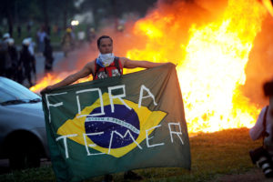 Students protest in front of the Congress in Brasilia against the bill that freezes government spending for 20 years, on November 29, 2016 Brazilian riot police fought an angry crowd of demonstrators outside Congress on Tuesday as lawmakers prepared to vote on austerity measures freezing government spending for 20 years. / AFP PHOTO / ANDRESSA ANHOLETE